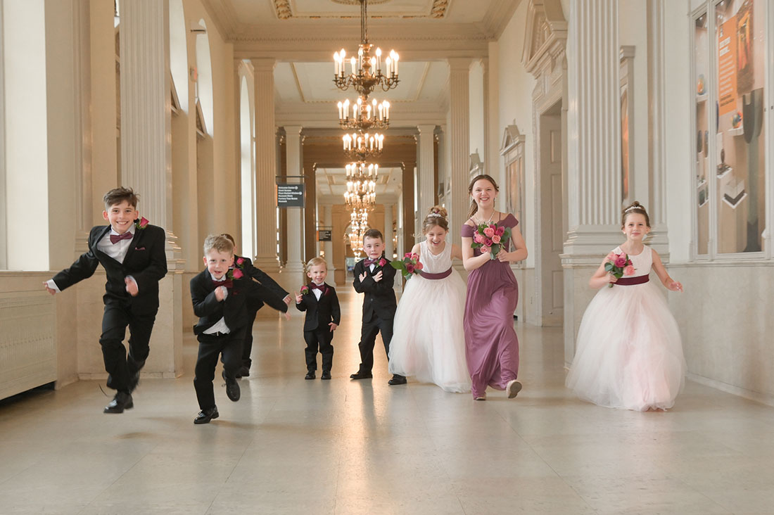 The grandkids in the wedding party race down the hallways at the Henry Ford Museum in Dearborn, Michigan.