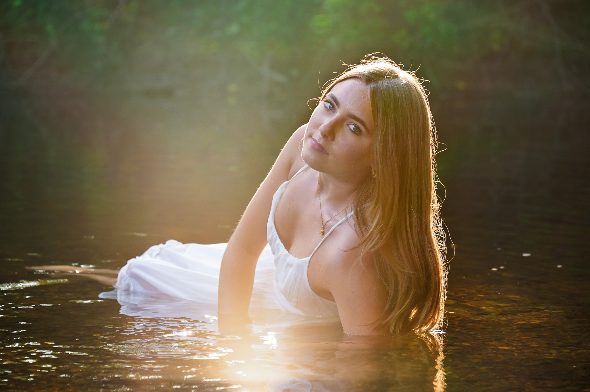 Birmingham's Seaholm High school senior posing in the water at sunset in Rochester, Michigan.
