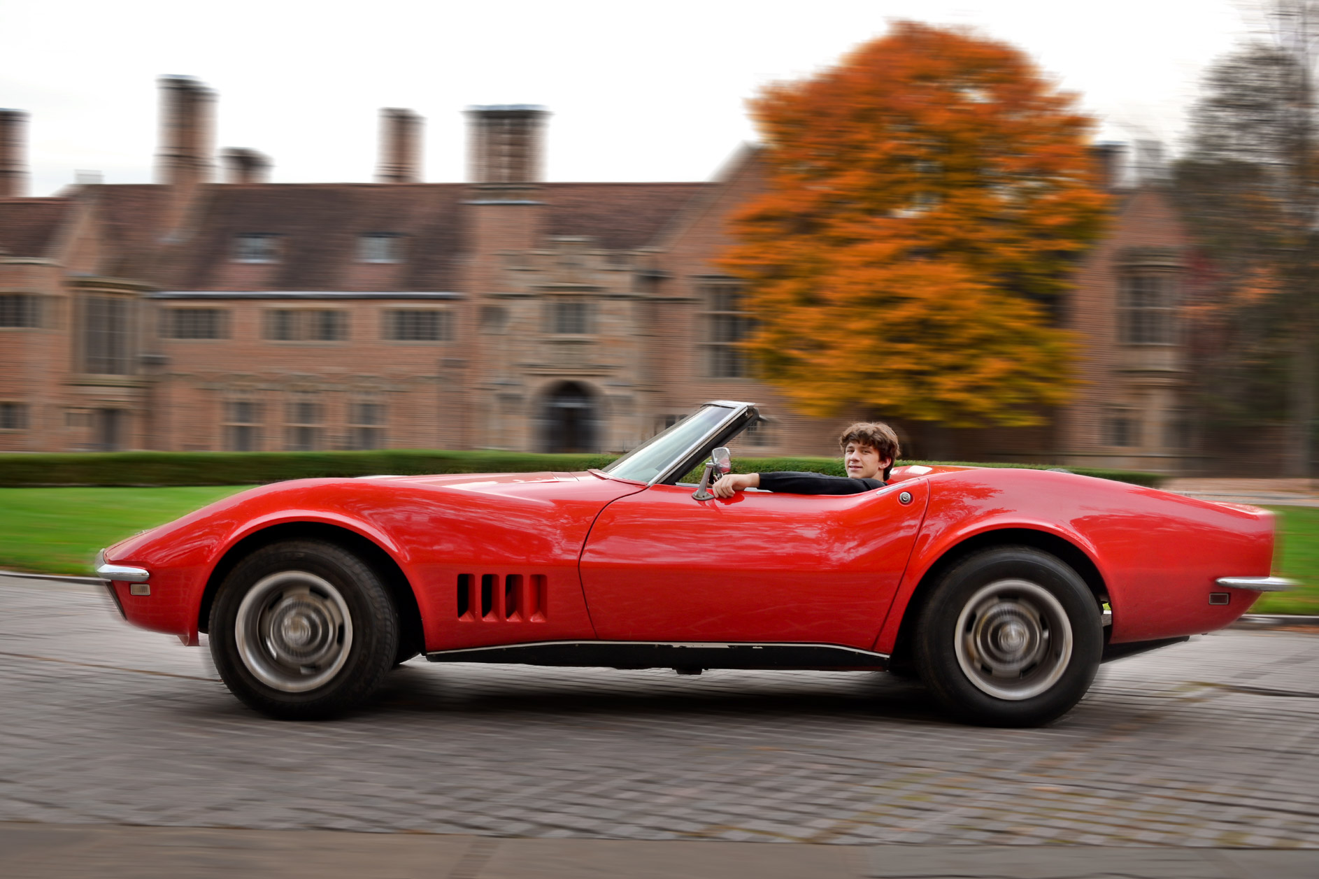 A Birmingham Seaholm senior drives an antique Corvette past the Meadowbrook Hall mansion in Rochester, Michigan.