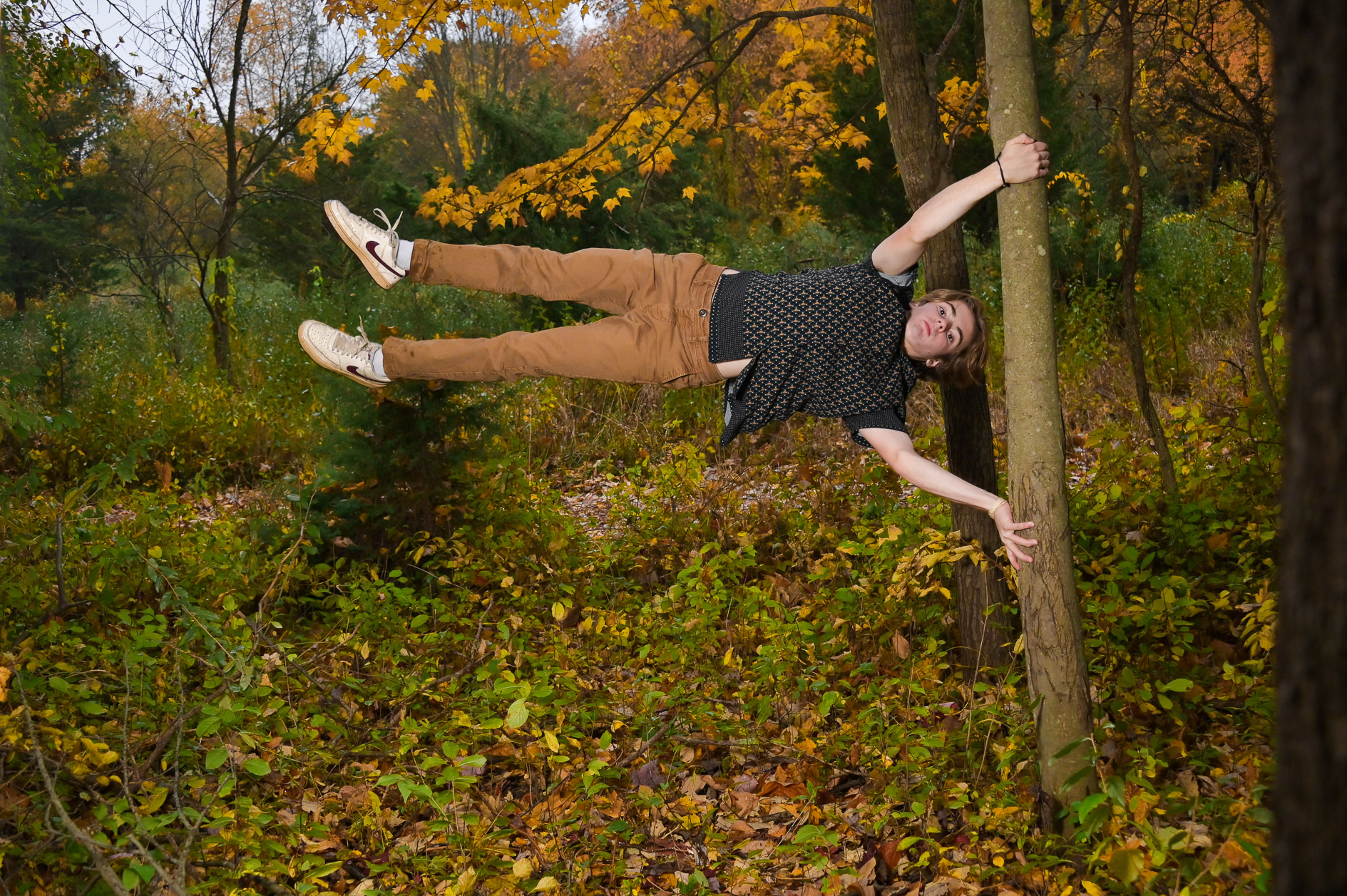 Troy High senior shows off a parkour trick with a tree in Troy, Michigan.