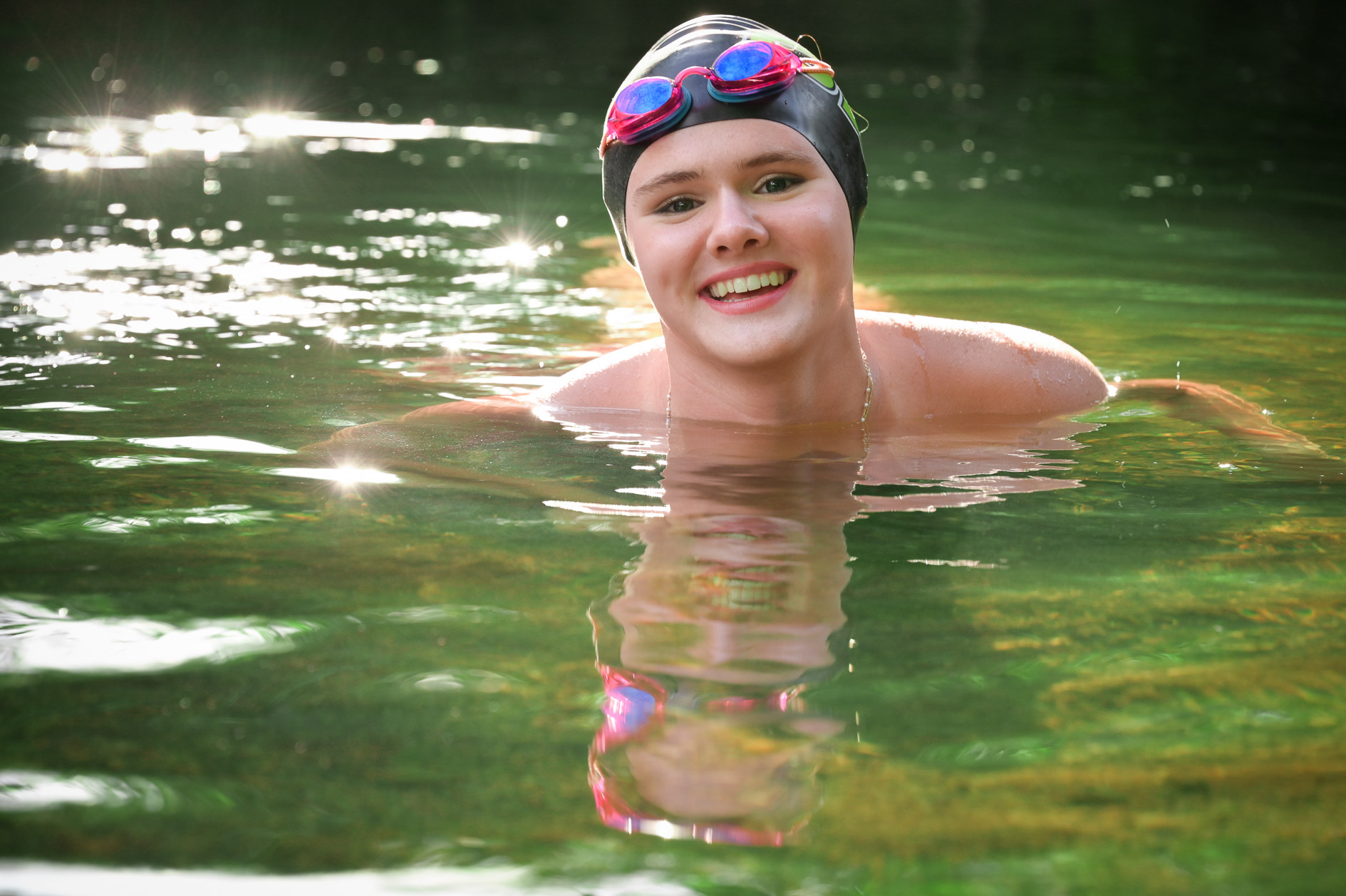 A Troy Athens swimmer gets her senior photos taken in Rochester in a lake instead of a swimming pool.