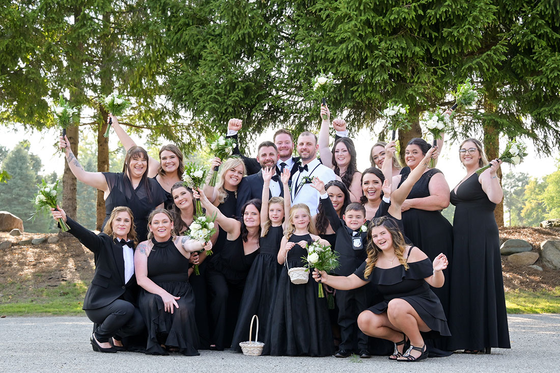 The full wedding party in a celebratory photo before their wedding at the Solitude Links Golf and Banquet Center in Kimball, Michigan.