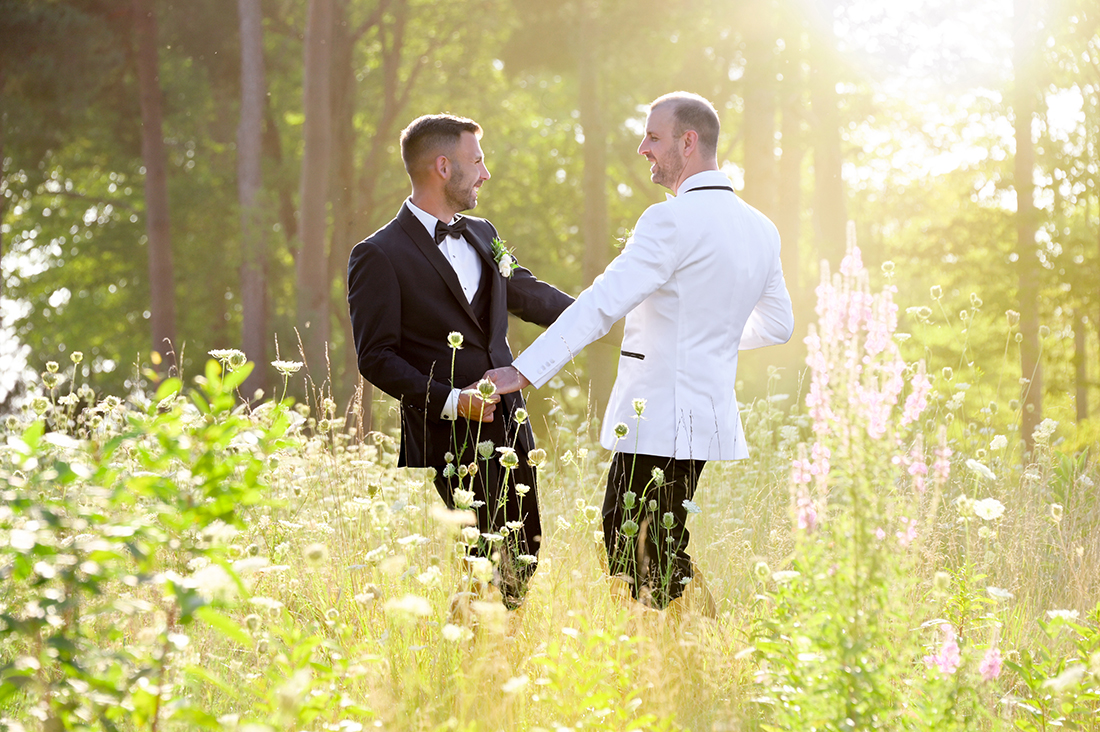 Two men dancing in a field before their wedding ceremony at the Solitude Links Golf and Banquet Center in Kimball, Michigan.