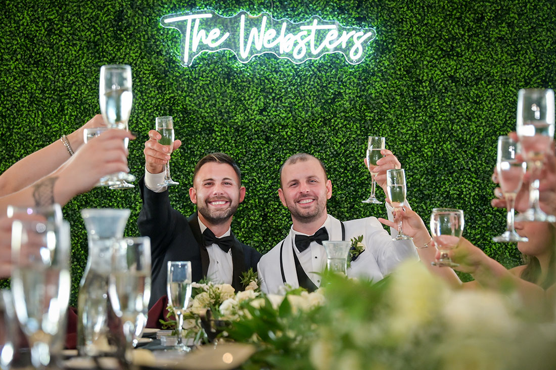 The grooms toasting their wedding party after their LGBTQ wedding at the Solitude Links Golf and Banquet Center in Kimball, Michigan.