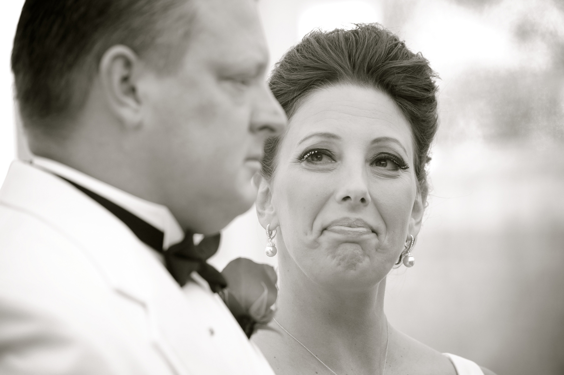 A 20's themed wedding in Michigan showcases Michigan wedding photographer's photograph of the bride gazing at her groom during a true 1920's themed wedding at Big Rock's wedding venue The Reserve, barn wedding.