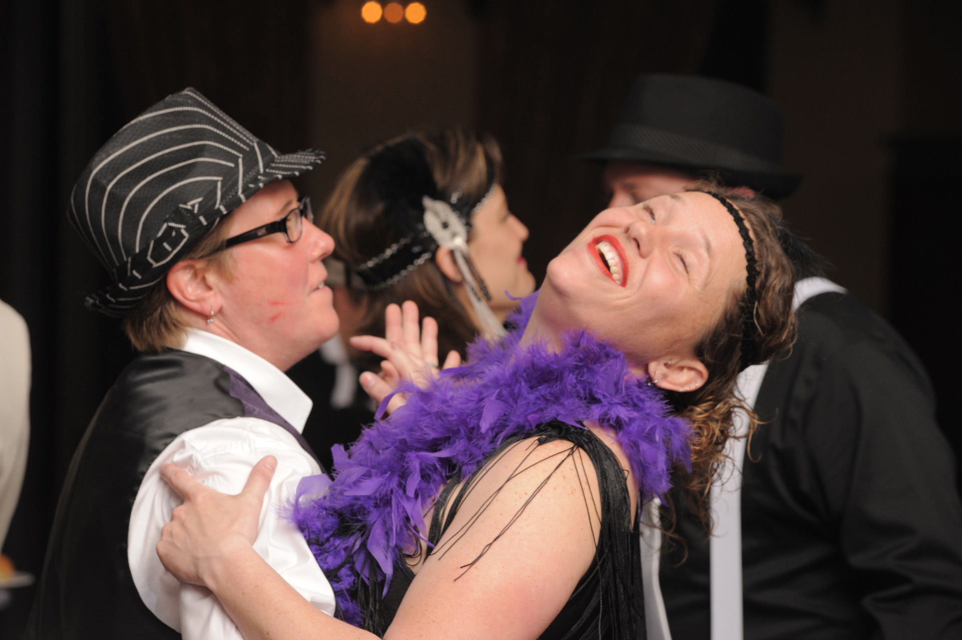 Michigan The Reserve wedding wedding photographer's photo of the wedding guests enjoying themselves in costume at a 1920's themed at their Michigan wedding at Birmingham, Michigan's Big Rock's wedding venue The Reserve.