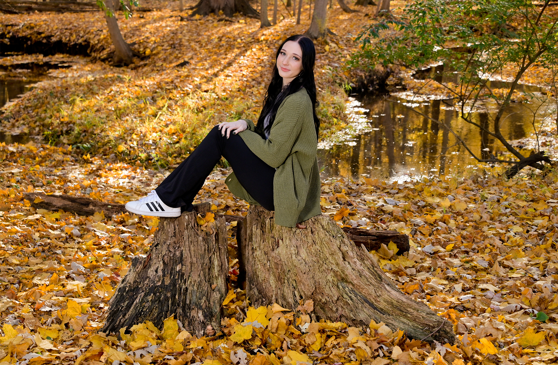  Troy senior pictures using what nature provides, like tree stumps outdoors near Troy, Michigan.