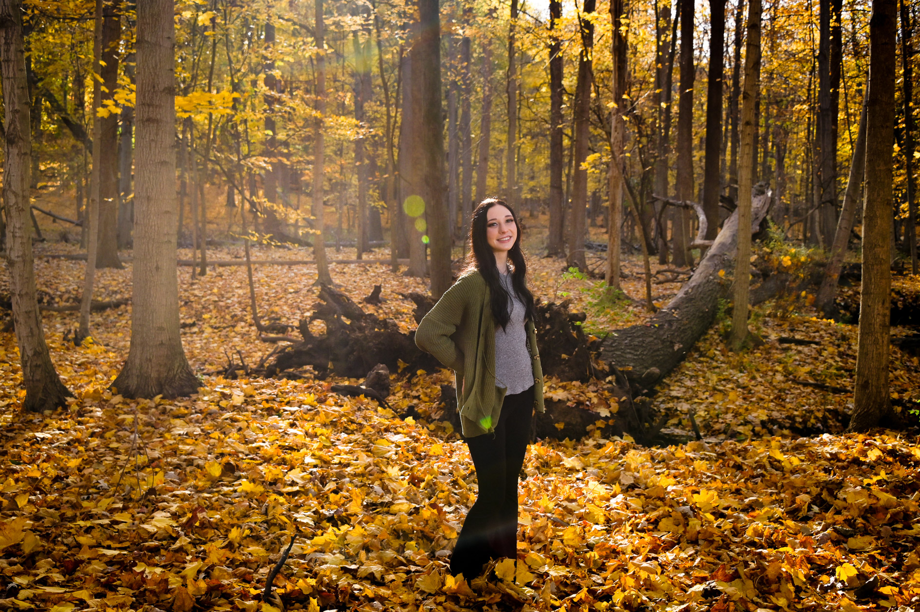 Troy senior posing in a forrest in the fall.
