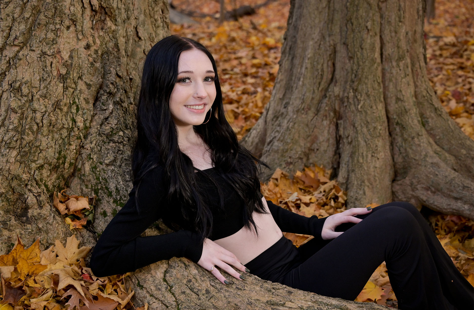 Senior sitting in trees for her senior photo near Troy, MI.