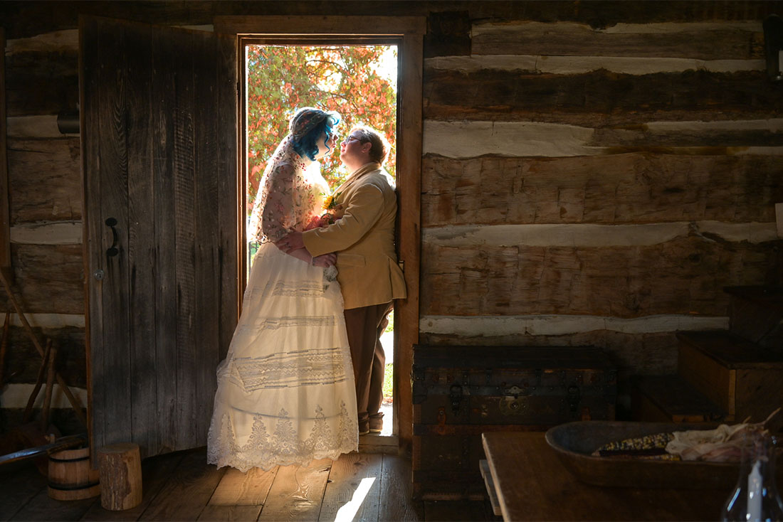 The LGBTQ couple snuggle in one of the log cabins at the Troy Historic Village in Troy, Michigan.