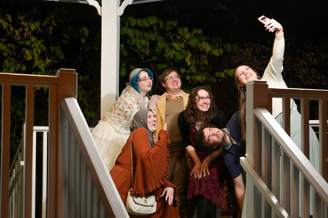 The couple poses with their friends as the wedding draws to a close at the Troy Historic Village in Troy, Michigan.