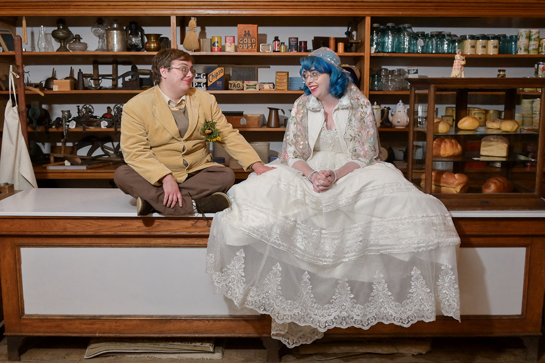 The couple hanging out together in the General Stor after their LGBTQ wedding at the Troy Historic Village in Troy, Michigan.