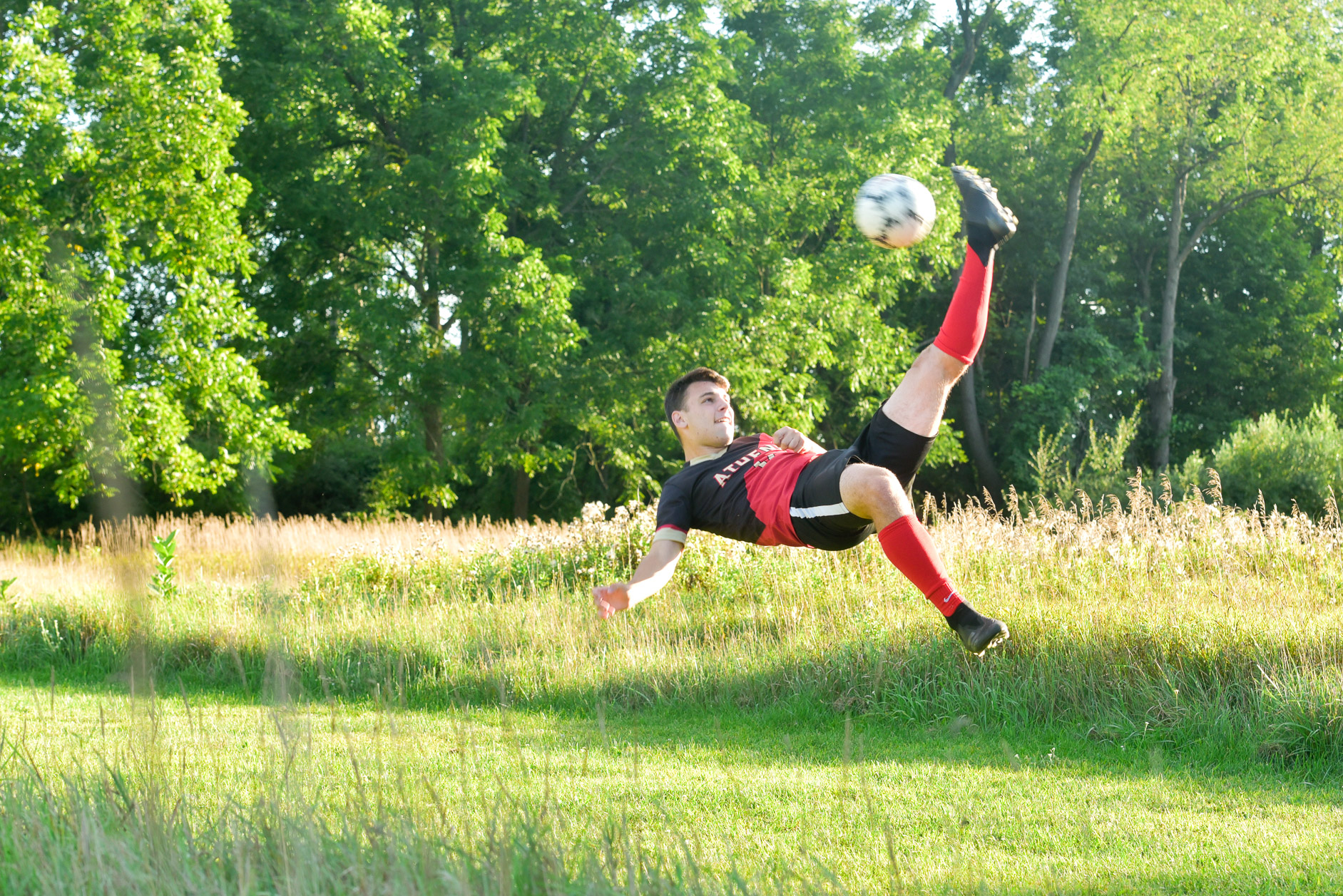 Troy Athen soccer star gets an out of the ordinary action soccer photo for his senior photo in Troy , Michigan.