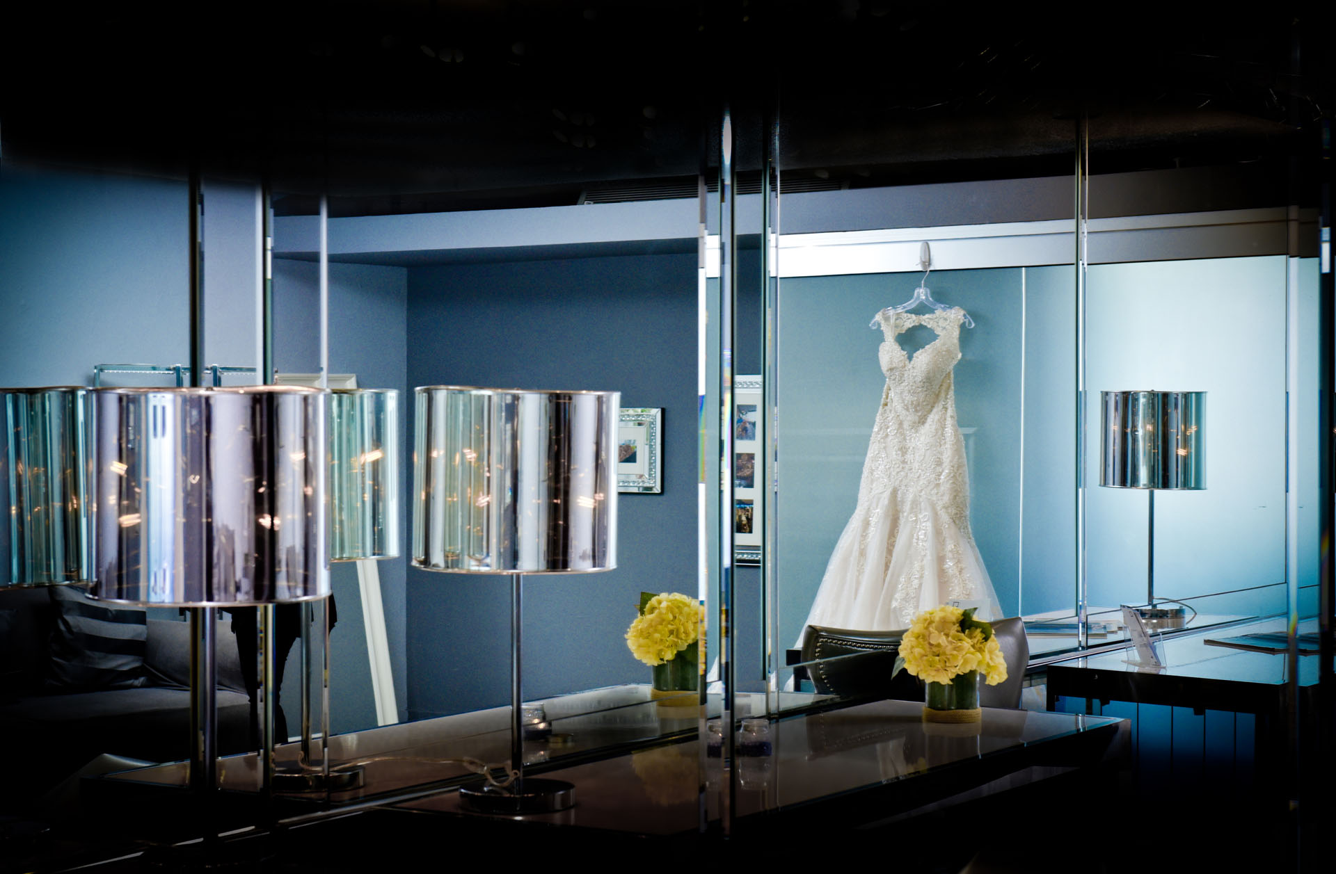 The bride's dress hangs in the dressing room at The Roostertail wedding venue in Detroit, Michigan.
