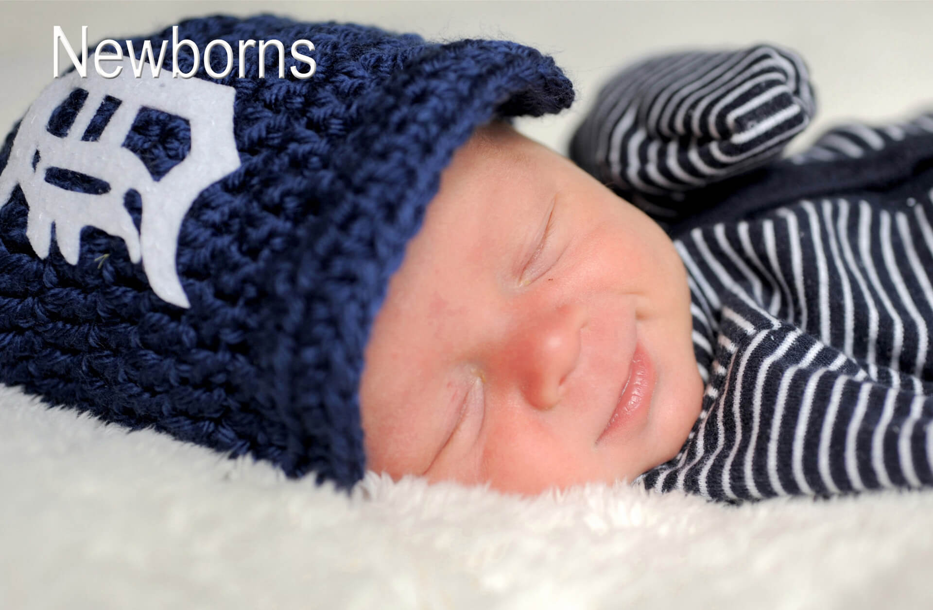 A newborn Detroit Tigers baby is photographed by newborn photographer Marci Curtis is the metro Detroit area of Michigan.