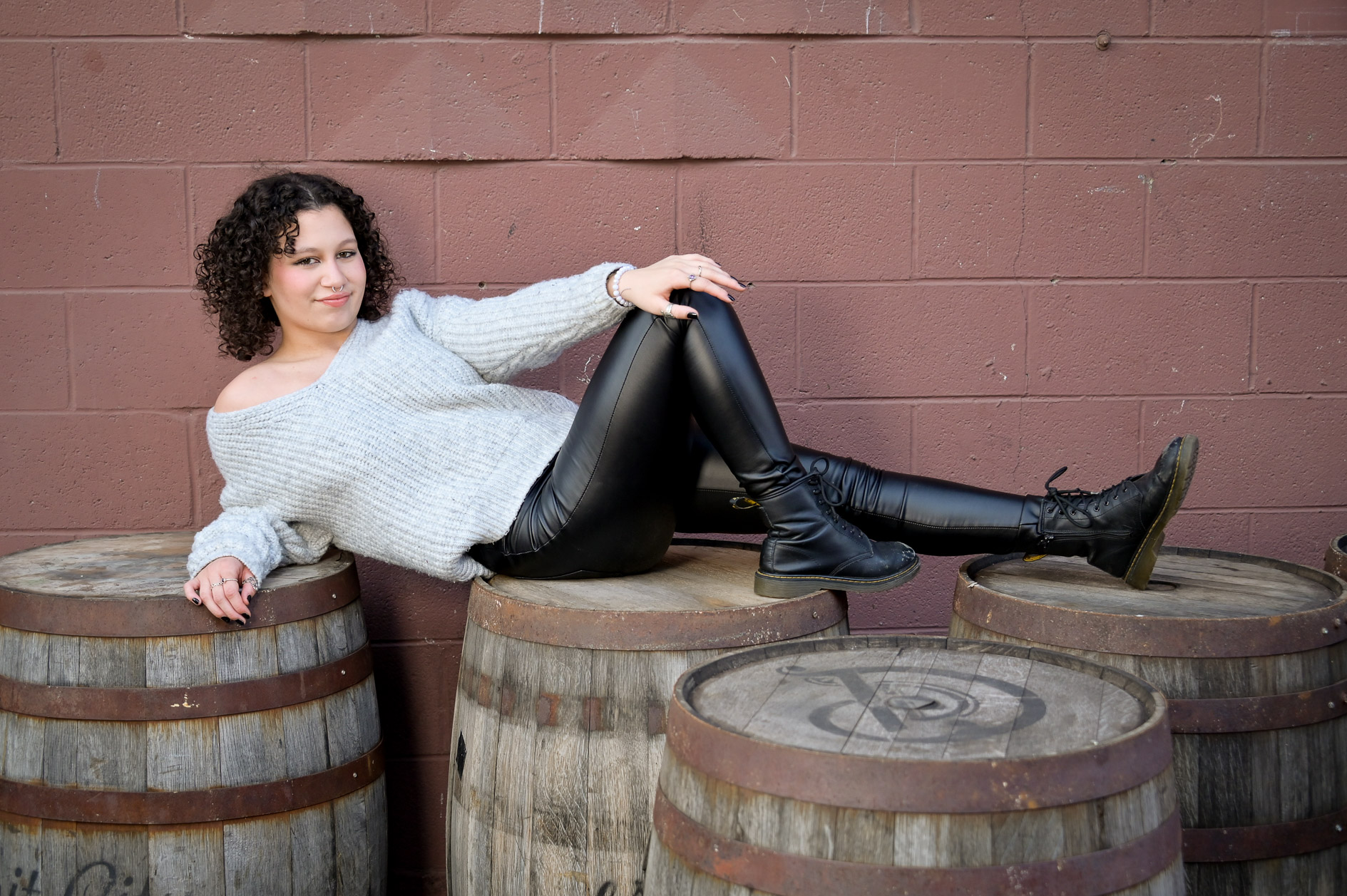 Using whatever is available to create theatrical senior photos like this Birmingham senior with barrels found in Detroit.