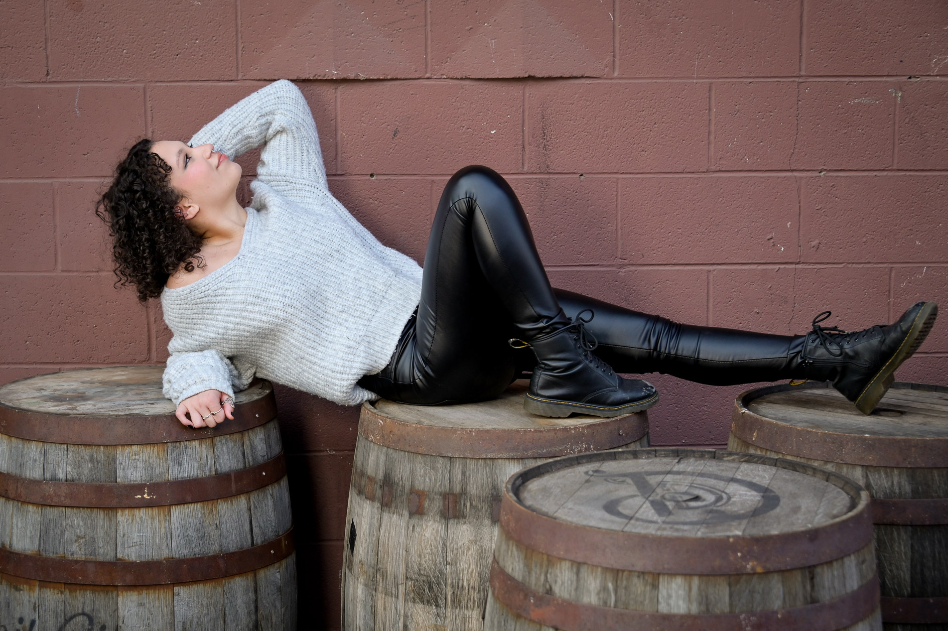 Theater senior strikes a dramatic pose for her senior photos in Detroit, Michigan.