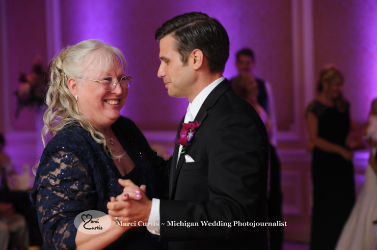 Wedding photography of a Michigan the groom dances with his mother in Dearborn, Michigan at their wedding reception at The Henry.