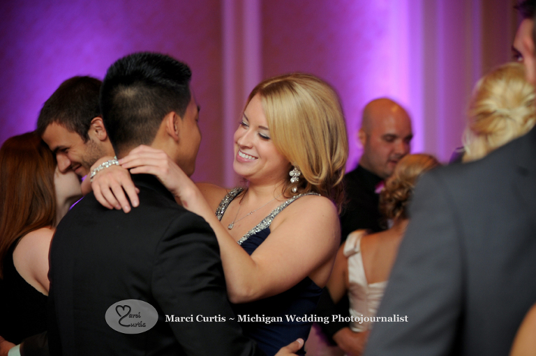 Wedding photography of a Michigan bride and groom's guests dance in Dearborn, Michigan at their wedding reception at The Henry.