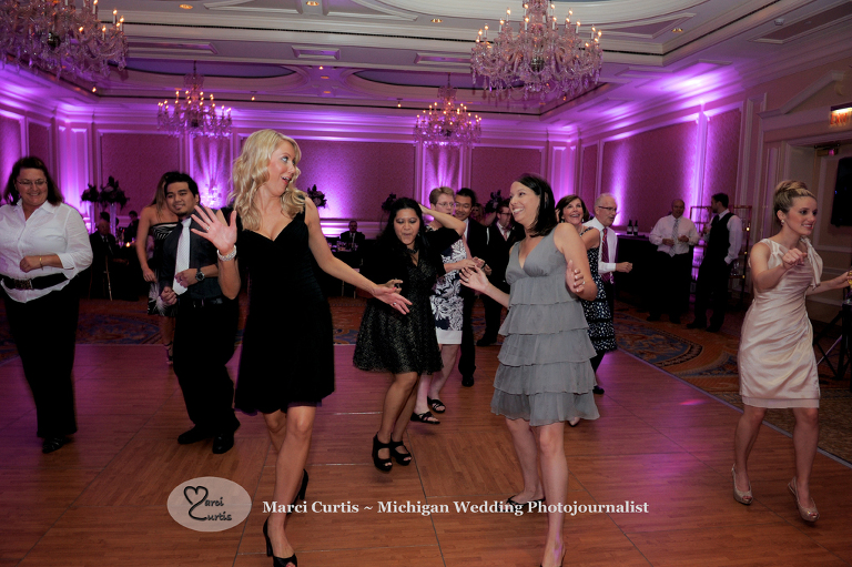 Wedding photography of a Michigan bride and groom's party in Dearborn, Michigan at their wedding reception at The Henry.