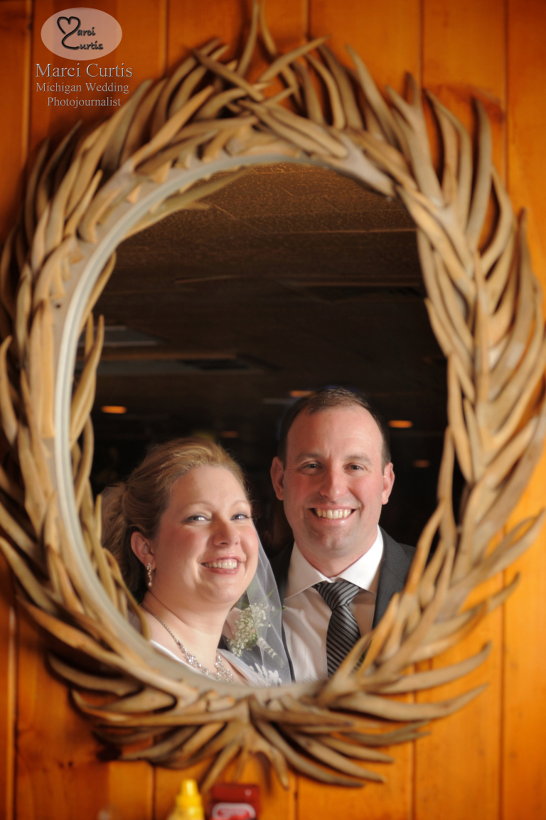 Wedding photo of the bride and groom at the Moose Preserve at Bloomfield Michigan's Iroquois Club. The rustic ambiance of the Moose Preserve isn't typical wedding fare, but it's pretty cool!