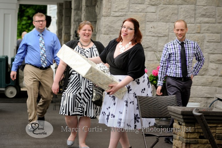 On of the guests is hustling into the Raisin River room for a wedding at Wellers in Saline, Michigan. With continuous down pours, she really wanted to protect that gift!