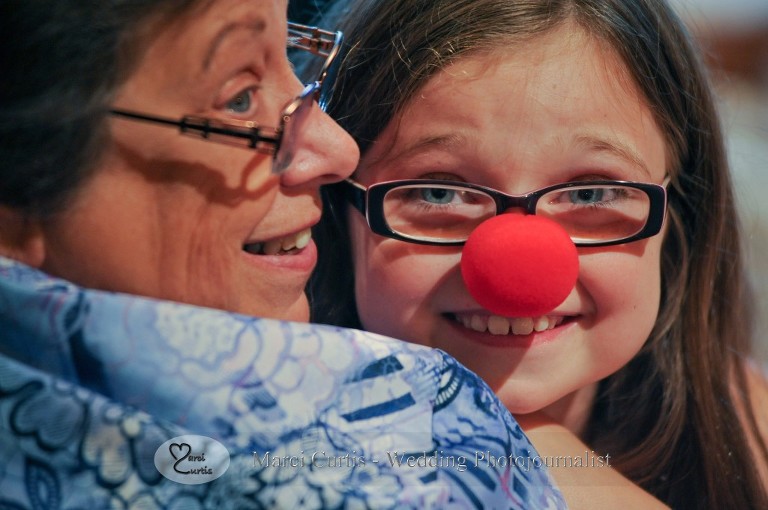 Another small relative goofs around with the red noses Gretchen provided to entertain their younger guests at their Wellers wedding in Saline, Michigan. Couples often forget how easy it can be to entertain their small guests until the dancing starts. This was genius!