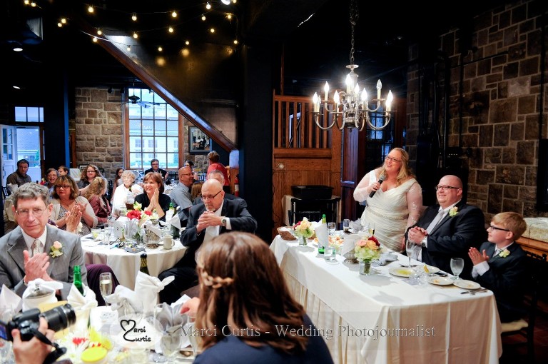 Gretchen gives a toast during their wedding dinner at Wellers River Raisin Room in Saline, Michigan. This room photographs nicely in the center of the room when the lights are up fully and there is still daylight.