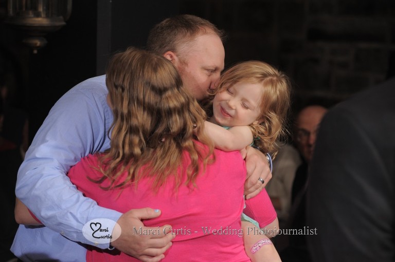 A family dances together during a slow dance at a wedding at Wellers Raisin River Room in Saline, Michigan.