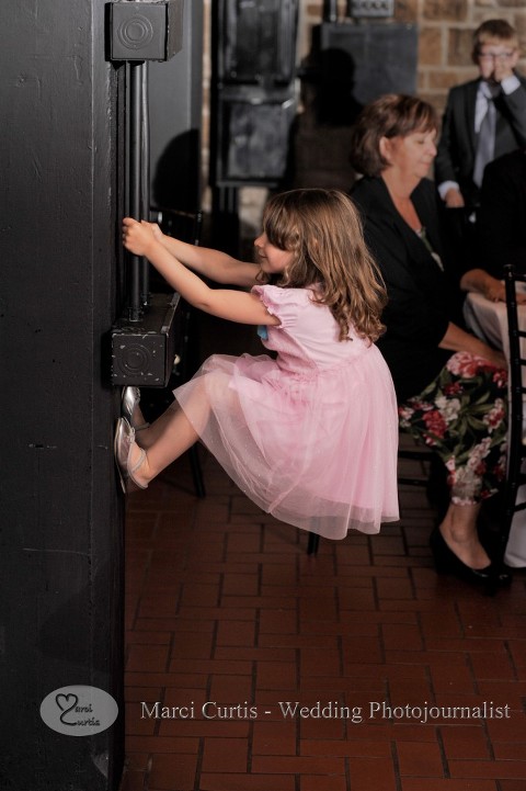 A small guest tried to climb a beam during a wedding reception at Wellers in Saline, Michigan.