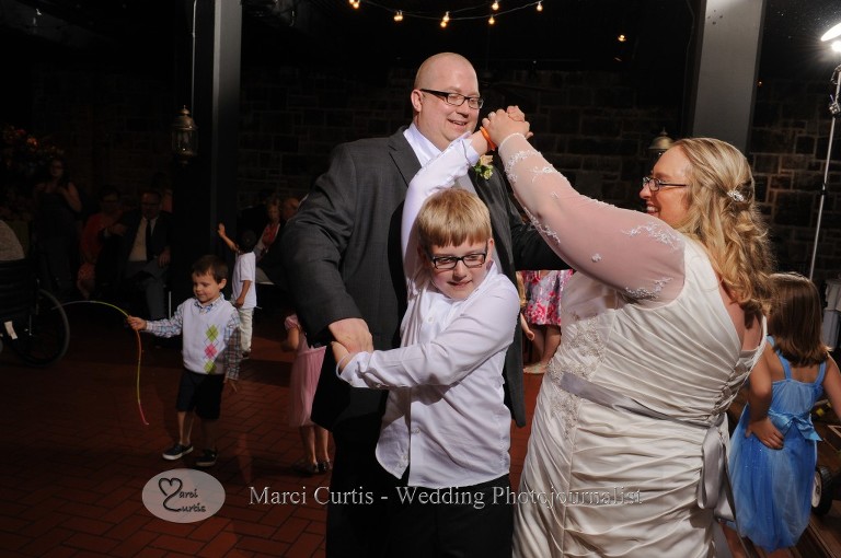 Dale and Gretchen dance with his son during the dancing at their Wellers wedding reception in the Raisin River Room.