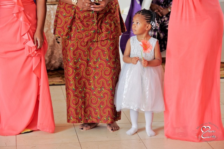 Detroit Nigerian Wedding Photographer photographs the flower girl who lined up to catch the bouquet.