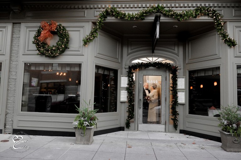 Wedding couple waits for photographer on a cold winter wedding day at the City Kitchen in Grosse Pointe, Michigan.