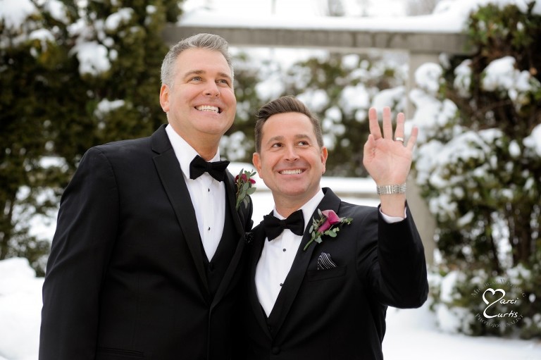 Same sex couple in Rochester, Michigan wave up to one other their family members during our shoot at the Royal Park Hotel in Rochester, Michigan.