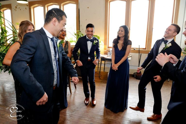 Wedding party plays games before their ceremony begins at the Jam Handy in Detroit.