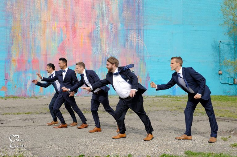 Gusty winds made standing still difficult during wedding party photos in Detroit, Michigan.