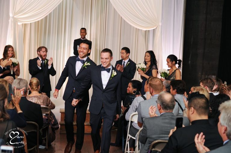 Grooms exit their Jam Handy wedding ceremony.