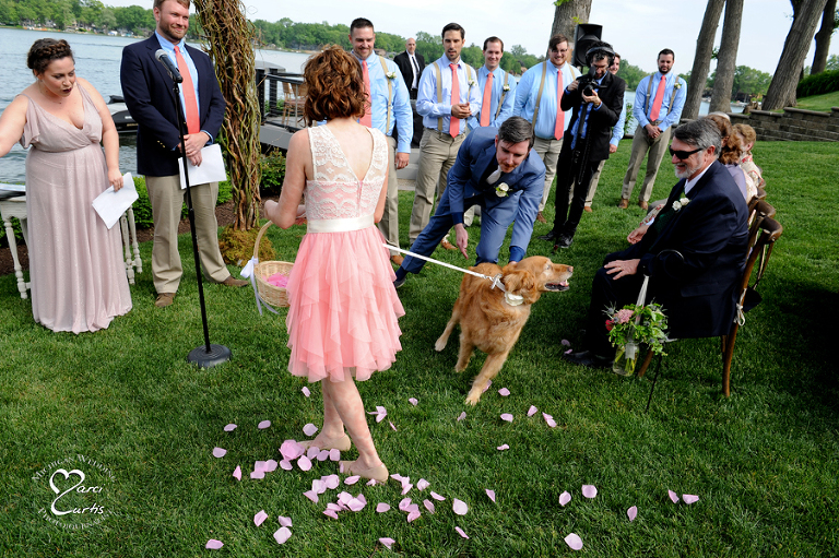 The dog decided to exit shortly after her entrance at the wedding ceremony of two stand up comics from NYC at their lakeside wedding ceremony in Michigan.