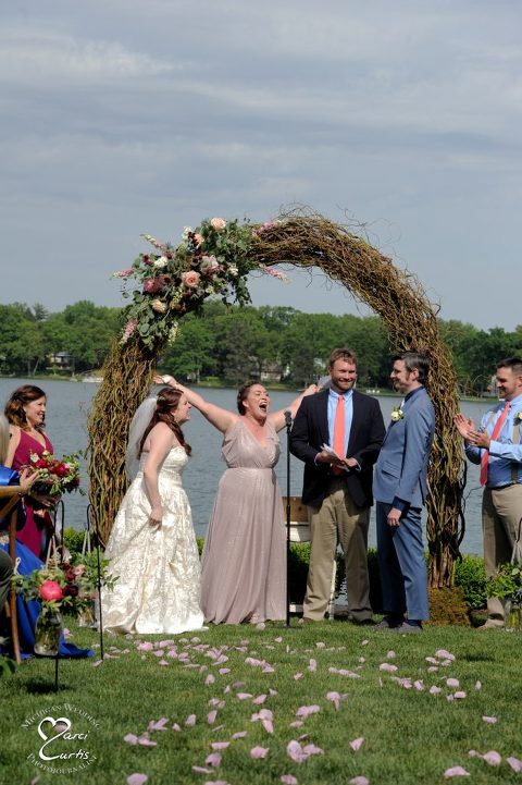 The officiant declares the two comedians are now officially wed at this lakeside wedding in Metro Detroit, Michigan.