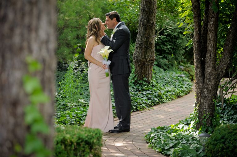 The bride and groom smooch shortly before their tiny second wedding at Cafe Cortina in Farmington Hills, Michigan.