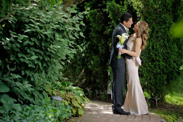 The bride and groom smooch shortly before their tiny second wedding at Cafe Cortina in Farmington Hills, Michigan.