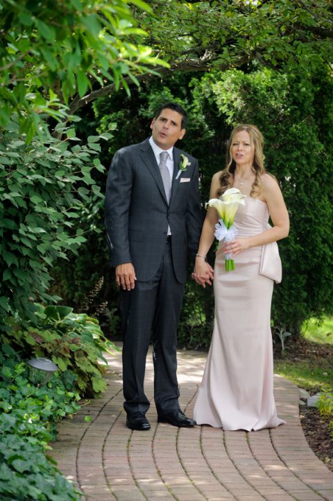 The bride and groom goof off just before their tiny second wedding at Cafe Cortina in Farmington Hills, Michigan.