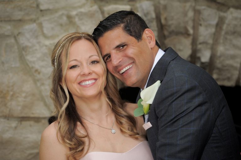 The bride and groom on the patio before their tiny second wedding at Cafe Cortina in Farmington Hills, Michigan.