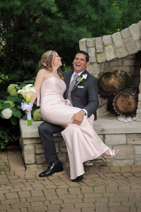 The bride and groom smooch on the patio before their tiny second wedding at Cafe Cortina in Farmington Hills, Michigan.