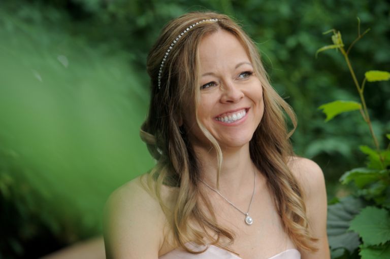 The bride and groom in the fresh garden before their tiny second wedding at Cafe Cortina in Farmington Hills, Michigan.