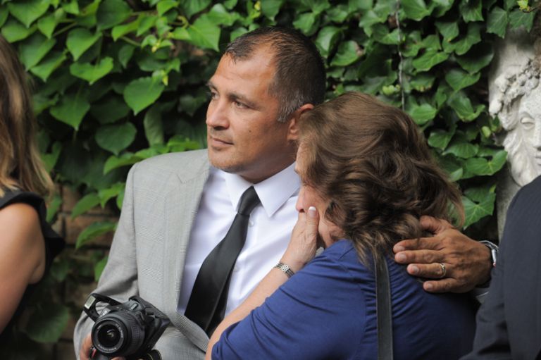 The mother of the groom cries during a tiny second wedding at Cafe Cortina in Farmington Hills, Michigan.
