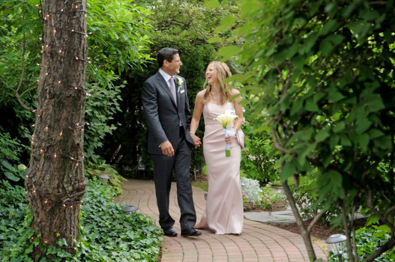 The bride and groom smooch shortly after their tiny second wedding at Cafe Cortina in Farmington Hills, Michigan.
