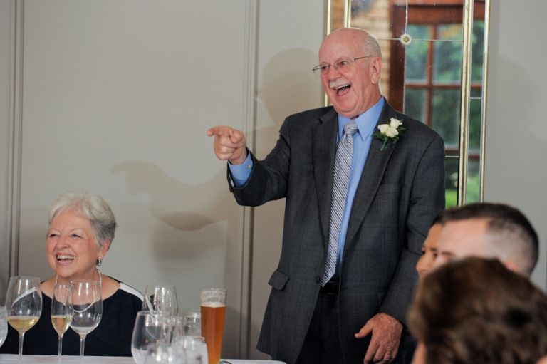 The bride's father teases his daughter and new son in law during the meal after the tiny second wedding at Cafe Cortina in Farmington Hills, Michigan.
