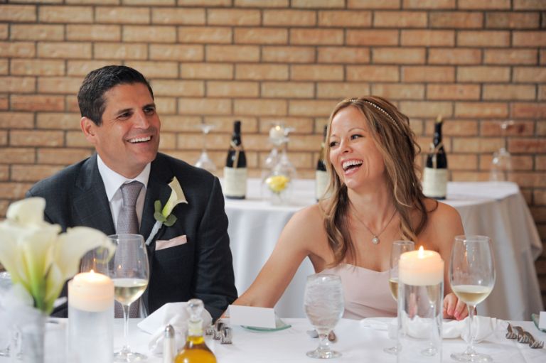 The bride and groom react to the bride's father's teasing his daughter and new son in law during the meal after the tiny second wedding at Cafe Cortina in Farmington Hills, Michigan.