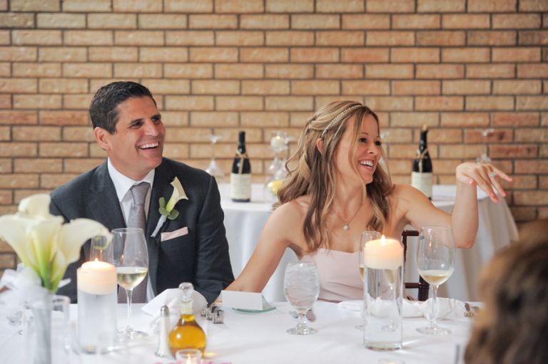 The bride and groom react to the bride's father's teasing his daughter and new son in law during the meal after the tiny second wedding at Cafe Cortina in Farmington Hills, Michigan.